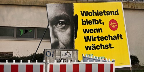 Large FDP election poster with Christian Lindner for the 2025 Bundestag election behind a barrier,