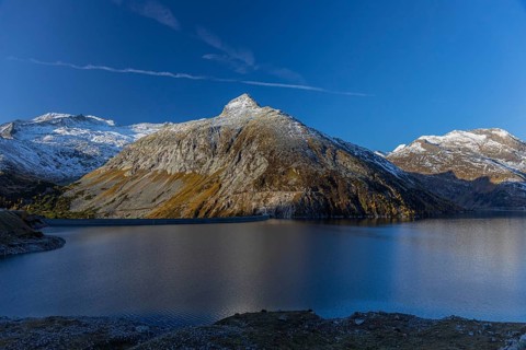 Kölnbrein reservoir and the Oberlecherspitzen mountain on a bright sunny morning. Seen from the