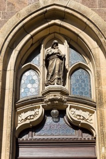 Christ with the Lamb, sandstone figure above the entrance to St Martin's Church, Weinböhla, Saxony,