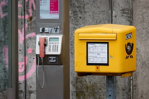 Krefeld, North Rhine-Westphalia, Germany - Public telephone box and post box