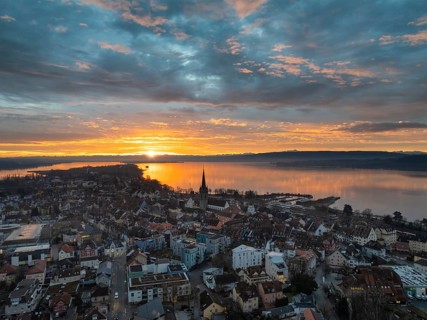 Aerial view of an atmospheric sunrise over the town of Radolfzell on Lake Constance with the