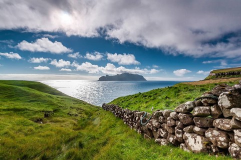 View of the island of Mykines, old stone wall, Gásadalur village, Vágar, Faroe Islands, Denmark,