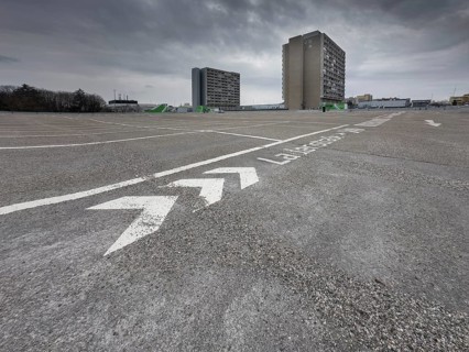 Symbolic image economic crisis, dark clouds in the sky, empty parking deck at