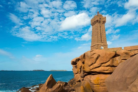 Lighthouse on rocky coast in front of a clear, cloudy sky, Phare de Men Ruz, Ploumanac'h,