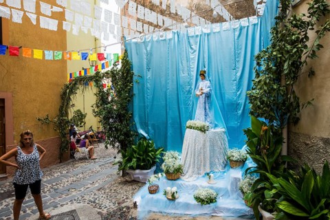 Decorated alley and celebrating people, feast of the Madonna of Regnos Altos, Bosa, district of