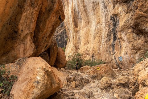 Tourist on the hiking trail through the gorge of Lissos near Sougia, Crete, Greece, Europe