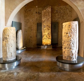 Carved stonework stelae display inside museum of Mayan Archaeology, Campeche city, Mexico, Central