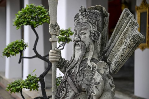 Stone statue of a Chinese warrior, guardian, Wat Pho, Temple of the Reclining Buddha, Bangkok,