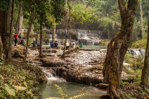 Tourists bathing in the Kuang Si waterfall near Luang Prabang, Laos, Asia