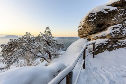 Winter magic at the Bastei Bridge, view of the Elbe and the Rauenstein shortly in front of sunrise,