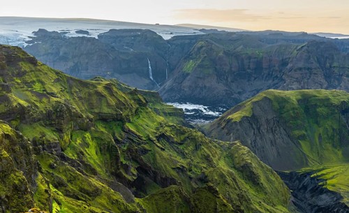 Moss-covered mountains at sunset, waterfalls on a cliff at Myrdalsjökull glacier, Pakgil, Iceland,