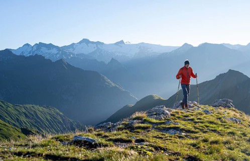 Hiker enjoying the mountain panorama in the morning, Venediger group, behind Dreiherrenkopf,
