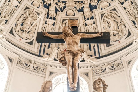 Crucifix and Baroque stucco work on the vault of the west choir in the interior of St Peter's