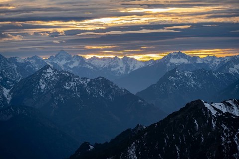 Mountain panorama with snow at sunset, in autumn, view from Kramerspitz, Bavarian Prealps, Bavaria,