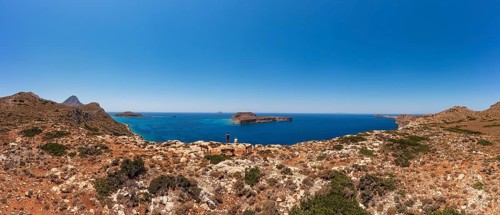Hikers on the way to the cape of the Gramvousa peninsula with a view of the island of Imeri