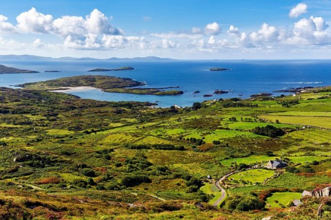 Typical coastline, blooming heather, view from above, spring clouds, panoramic road Ring of Kerry,