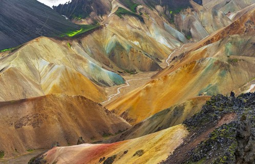 Small river between colourful rhyolite mountains, volcanic landscape, erosion landscape, view from