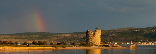 Old tower ruins on the coast with a rainbow in the distance at dusk, Vecka kula, Vecka Kula,