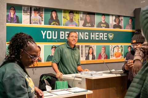Detroit, Michigan - At Wayne State University on Noel Night, a recruiter talks to potential