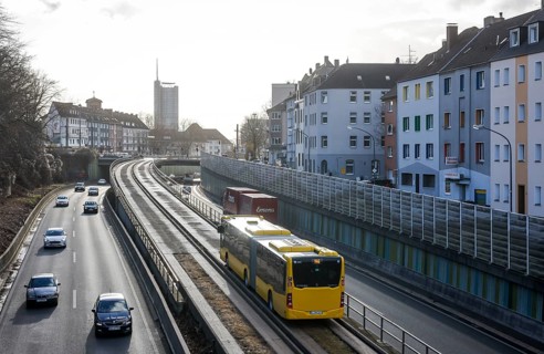 Essen, North Rhine-Westphalia, Germany - Cars and a public bus drive on the A40 motorway through