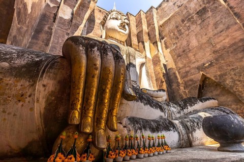 Giant Buddha statue in the temple Wat Si Chum, UNESCO World Heritage Sukhothai Historical Park,