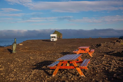 Motorhome parking on the shoreline, south of Sandvik with crashing waves. Rough nature