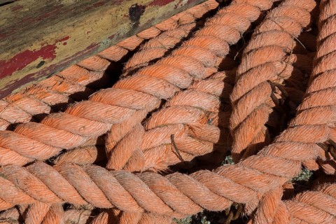 Close-up of old and worn heavy duty strong salmon colored rope on the ground, Monterosso, Cinque