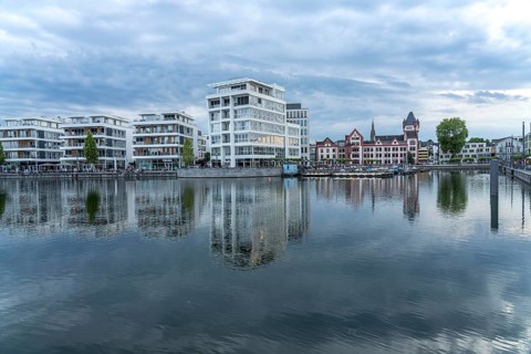 The Hörder Castle and modern office buildings on Lake Phoenix in Dortmund, North Rhine-Westphalia,
