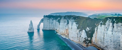 The coast of Etretat (Étretat) at sunrise, cliffs with Porte d'Aval and Aiguille rock needle,