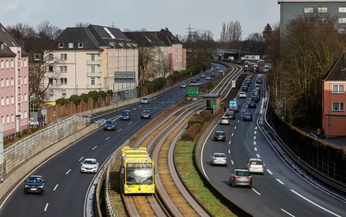 Essen, North Rhine-Westphalia, Germany - Cars and a public bus drive through Essen city centre on