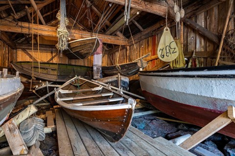 Old fishing boats in a shed, fishing village Nusfjord, Lofoten, Norway, Europe