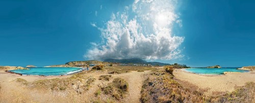 360° panorama with clear sea and Frangolimiona beach under blue sky with dramatic clouds, calm and