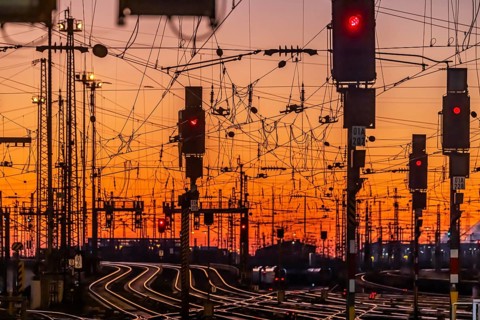 Track apron in the evening with sunset. Frankfurt am Main main station with rails, line mast and