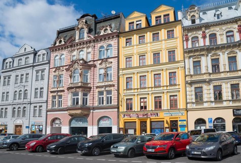 Row of colourful, historic houses under a blue sky, parked cars in front, Liberec, Reichenberg,