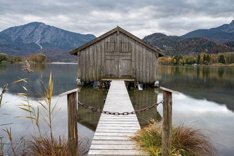 Boathouse in the lake, Lake Kochel in autumn with reflection, Upper Bavaria, Bavaria, Germany,