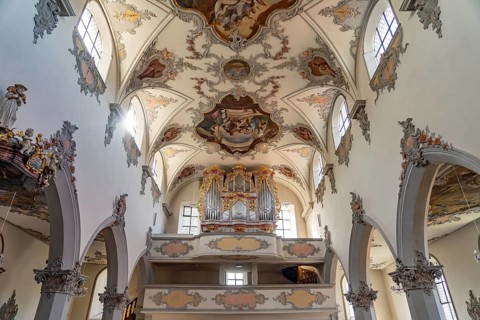 Church organ and ceiling fresco in the interior of the town church of Laufenburg, Aargau,