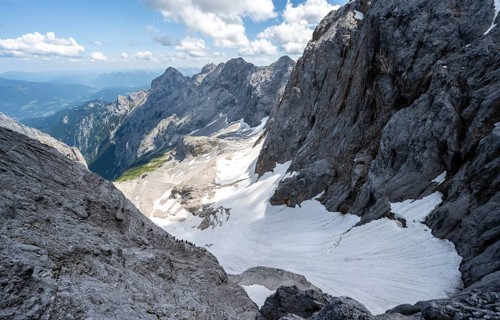View of mountain basin with snow field of the Höllentalferner and Höllental, Zugspitze via ferrata,