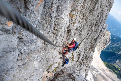 Mountaineer with helmet climbing in a secured via ferrata, Zugspitz via ferrata, ascent to the