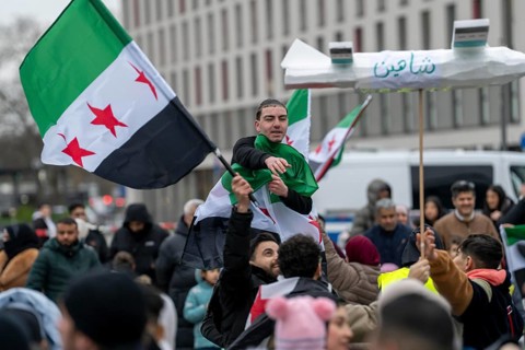 People celebrate the end of the Assad regime after the change of power in Syria at a rally on the