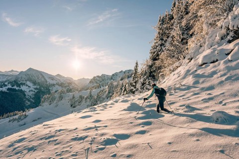 Hiking in the snow in the snow-covered winder landscape in the Alps at Neunerköpfle in the