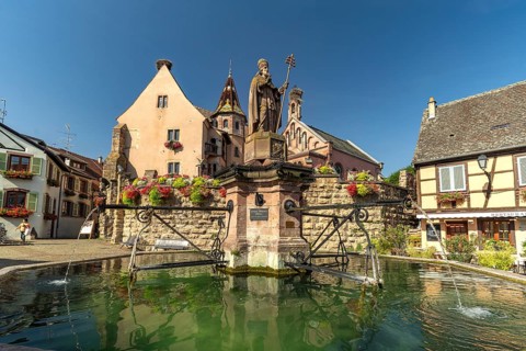 Fountain Fontaine de Saint-Léon and St Leo's Chapel in Eguisheim, Alsace, France, Europe