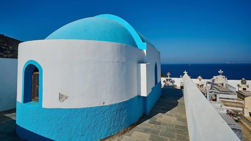 Small chapel in blue and white next to a cemetery with sea view, Pali village, Pali, Volcanic