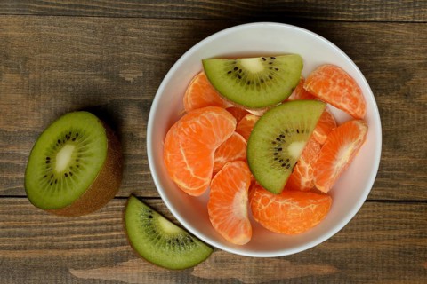Clementine pieces and kiwi slices in peel