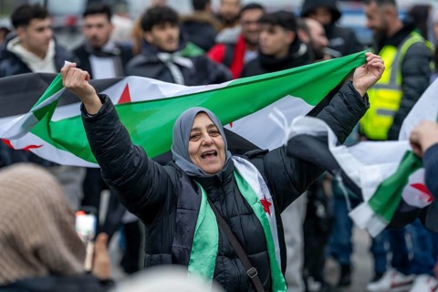 Syrian woman celebrate the end of the Assad regime after the change of power in Syria at a rally on
