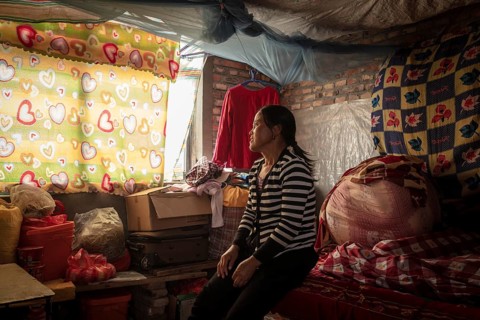 Labourer Ma Jian Hui at her sleeping place, the workers live in the respective buildings where the