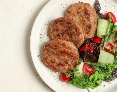Fried cutlets, minced beef, with vegetable salad, top view, no people