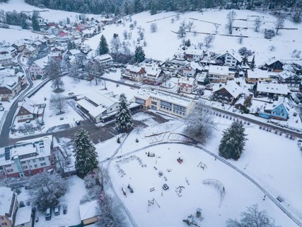 Snowy village with playground, surrounded by hills and trees, Enzklösterle, Calw district, Black