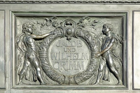 Relief on the Brothers Grimm National Monument, Jacob and Wilhelm with laurel wreath, inscription,