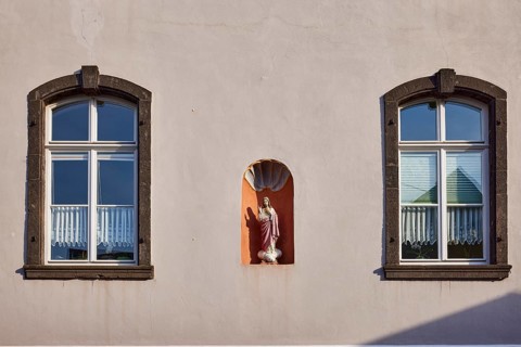 Historic building, facades with windows and house Madonna, Mesenich, district of Cochem-Zell,