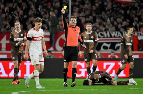 Referee Dr Felix Brych shows Yannik Keitel VfB Stuttgart (05) yellow card yellow caution for foul
